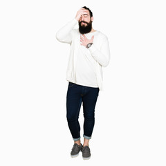 Young hipster man with long hair and beard wearing sporty sweatshirt Touching forehead for illness and fever, flu and cold, virus sick