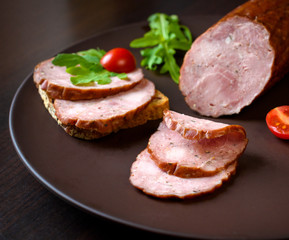 Smoked sausage with arugula and tomato