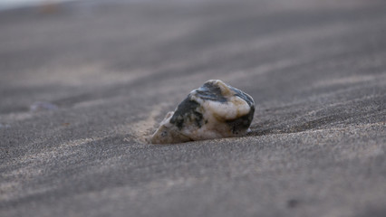 A sandy beach as the tide goes out on a cold evening 