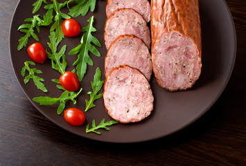 Smoked sausage with arugula and tomato