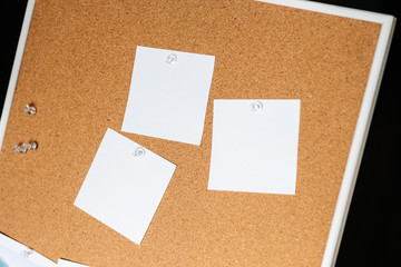 Fototapeta premium White notes on cork bulletin board