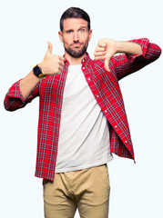 Handsome man wearing casual shirt Doing thumbs up and down, disagreement and agreement expression....