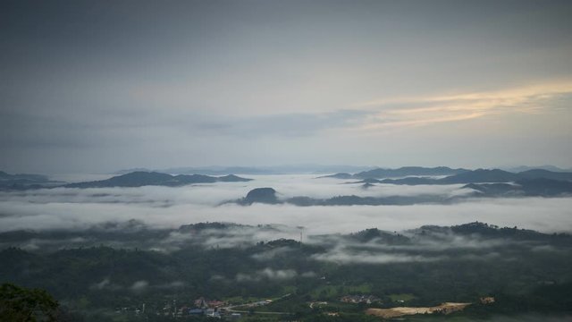 Time-lapse of moving stratus clouds across over the small city, view from Baha camp,mount Stong, Kelantan Malaysia during sunrise.