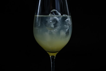 Studio Shot of Glass with drink against black background