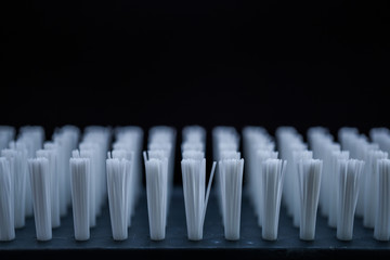 Close-up of White Brush Bristles against Black Background.