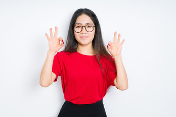 Beautiful brunette woman wearing glasses over isolated background relax and smiling with eyes closed doing meditation gesture with fingers. Yoga concept.