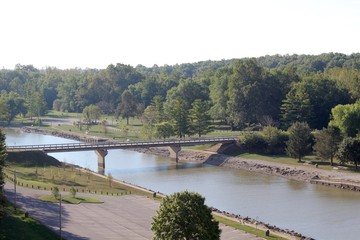Fototapeta na wymiar A aerial view of the highway bridge over the creek in park.