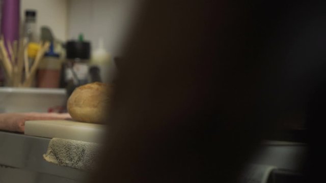 Chef at the restaurant cutting bread