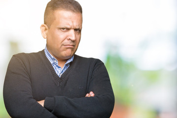 Handsome middle age man over isolated background skeptic and nervous, disapproving expression on...