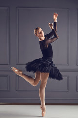 Ballerina ballet dancer over gray background.