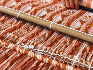 Close up of traditional weaving technique IKAT for making scarfs or Macana or other fabric by hand...