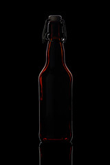 glass beer bottle on a black background