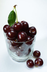 Ripe cherry in a glass isolated on white