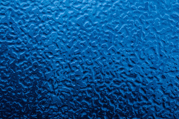 Icy patterns on a car window. Great abstract blue background