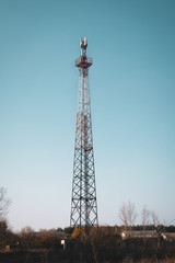 Cellular base station telecommunication tower located among residential buildings