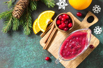 Cranberry sauce. Homemade Thanksgiving Cranberry Sauce with Orange Zest and ingredients for cooking on stone table. Top view. Free space for your text.
