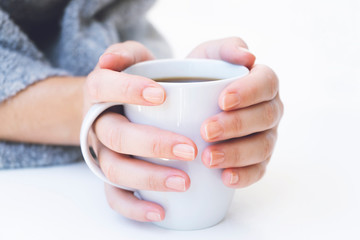 Fototapeta na wymiar hands holding hot cup of coffee or tea