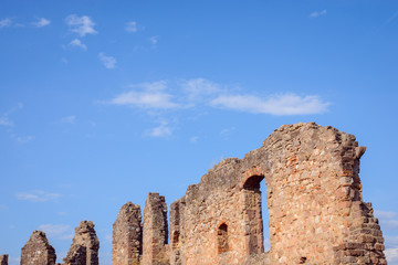 Ruins of castle. Old walls of dilapidated castle against blue sky in the evening