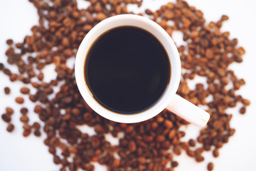 White coffee cup and coffee beans on white background.