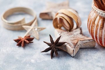 Obraz na płótnie Canvas Star anise and wooden Christmas Star on bright wooden background. Close up. 