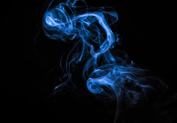 Colored blue smoke on a black background