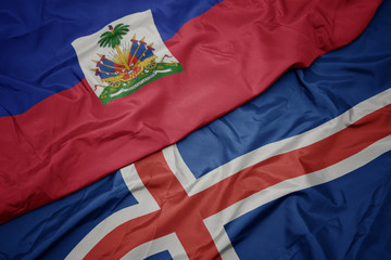 waving colorful flag of iceland and national flag of haiti.