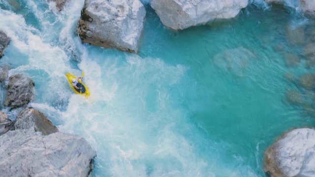 A man kayaking through rapids