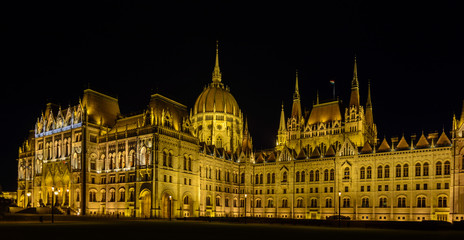 Obraz na płótnie Canvas Parliament is the most beautiful building in Budapest and the largest in Hungary. Embankment with palaces and residences in the lights. Architectural Style - Neo-Gothic