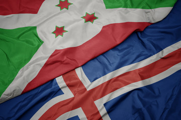 waving colorful flag of iceland and national flag of burundi .