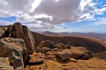 View on the dry soil of Fuerteventura with a passing road