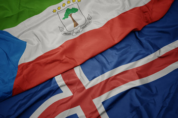 waving colorful flag of iceland and national flag of equatorial guinea.