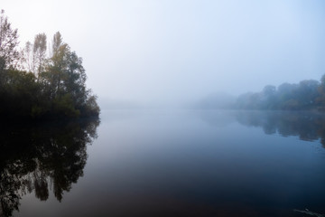 sunrise over foggy lake