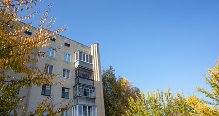 An old residential building against the gray sky. Architecture of Soviet Union times.