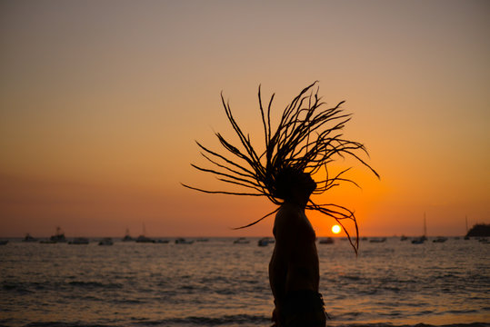 dreadlock young man in sunset