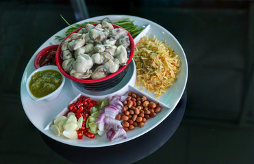 Oysters food and chili sauce,Thai food is Oysters with Herbs or Oyster Spicy Salad. Oysters with chili paste, fried onions,red onion fried Thai cuisine style. seafood chili sauce and horse tamarind.