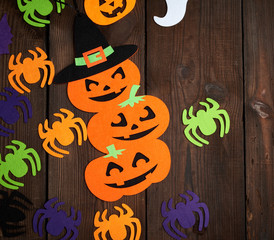 spider and orange pumpkin felt figures on a brown background