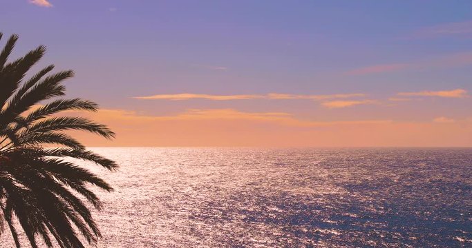 Evening sunset sky over sea calm surface, clear peaceful water texture, open horizon line panoramic natural real time, silhouetted susnet magic, romantic video background, empty Hawaii Maui Pacific 4K