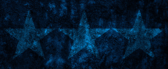 Three stars on a navy blue rusty metal wall
