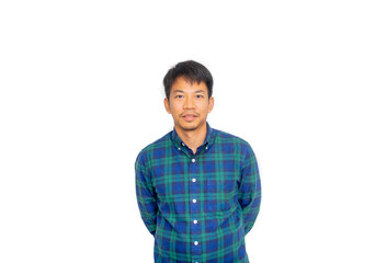 A filthy Asian man in blue plaid shirt standing with his hands at the back and looking through the camera.