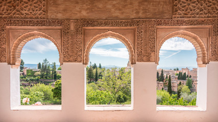 window over the heaven, tree arch windows in generalife ornate with arabic motif. alhambra. spain