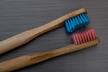 wooden tooth brushes on brushed metal background