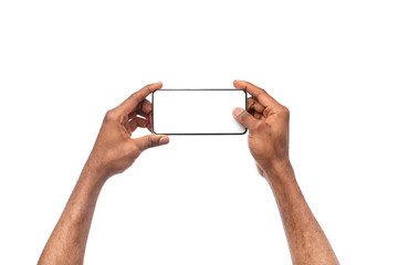 Black male hands taking photo on smartphone with blank screen - obrazy, fototapety, plakaty