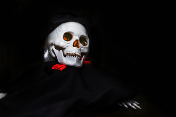 Creepy smiling skeleton skull close up on black background with copy space, death and mystery concept, halloween