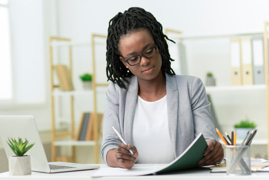 Afro Business Lady Taking Notes Working In Modern Office