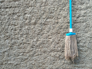 Mop the floor with a background wall with a rough surface