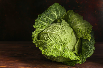 Fresh savoy cabbage on wooden table