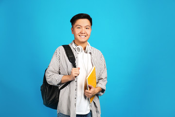 Portrait of Asian student on color background