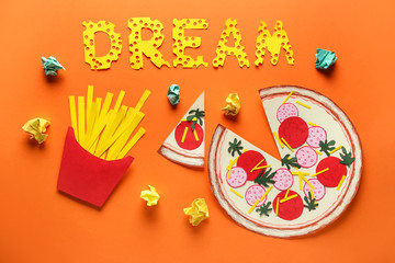 Word DREAM with paper fast food on color background