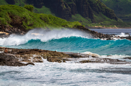 Breaking wave on the Beach with Mountains in the background