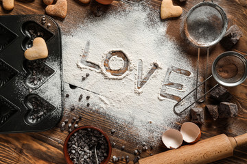 Word LOVE written on flour, top view
